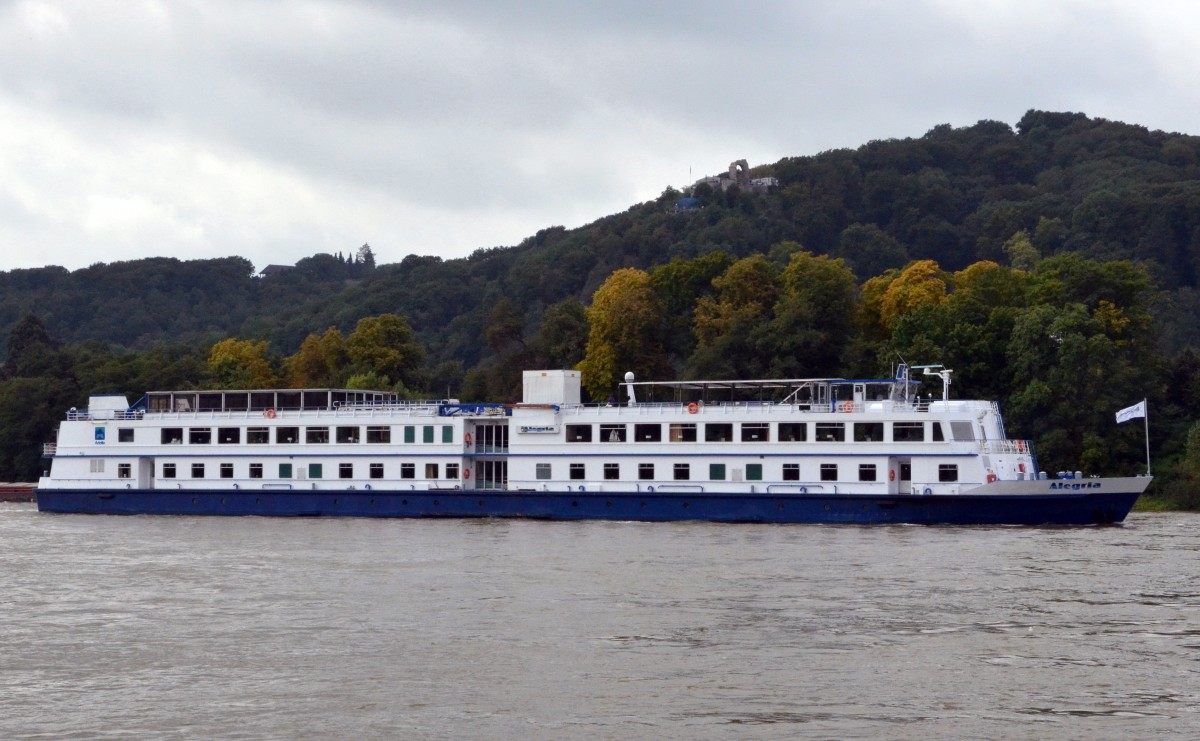 River cruise ship sailing along a wooded river valley