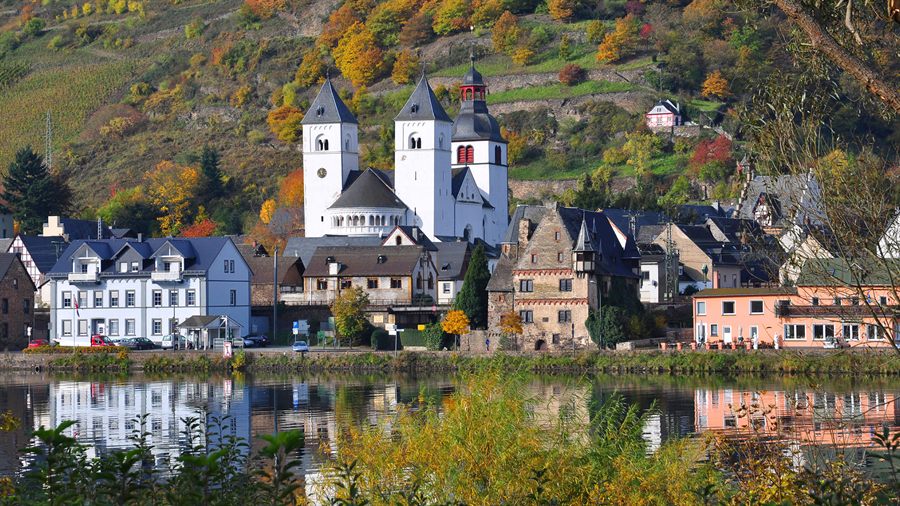 Riverside village with twin church towers